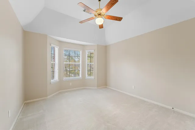 a bedroom with bed and window