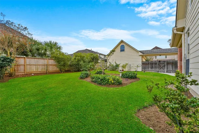 a view of a brick house next to a yard