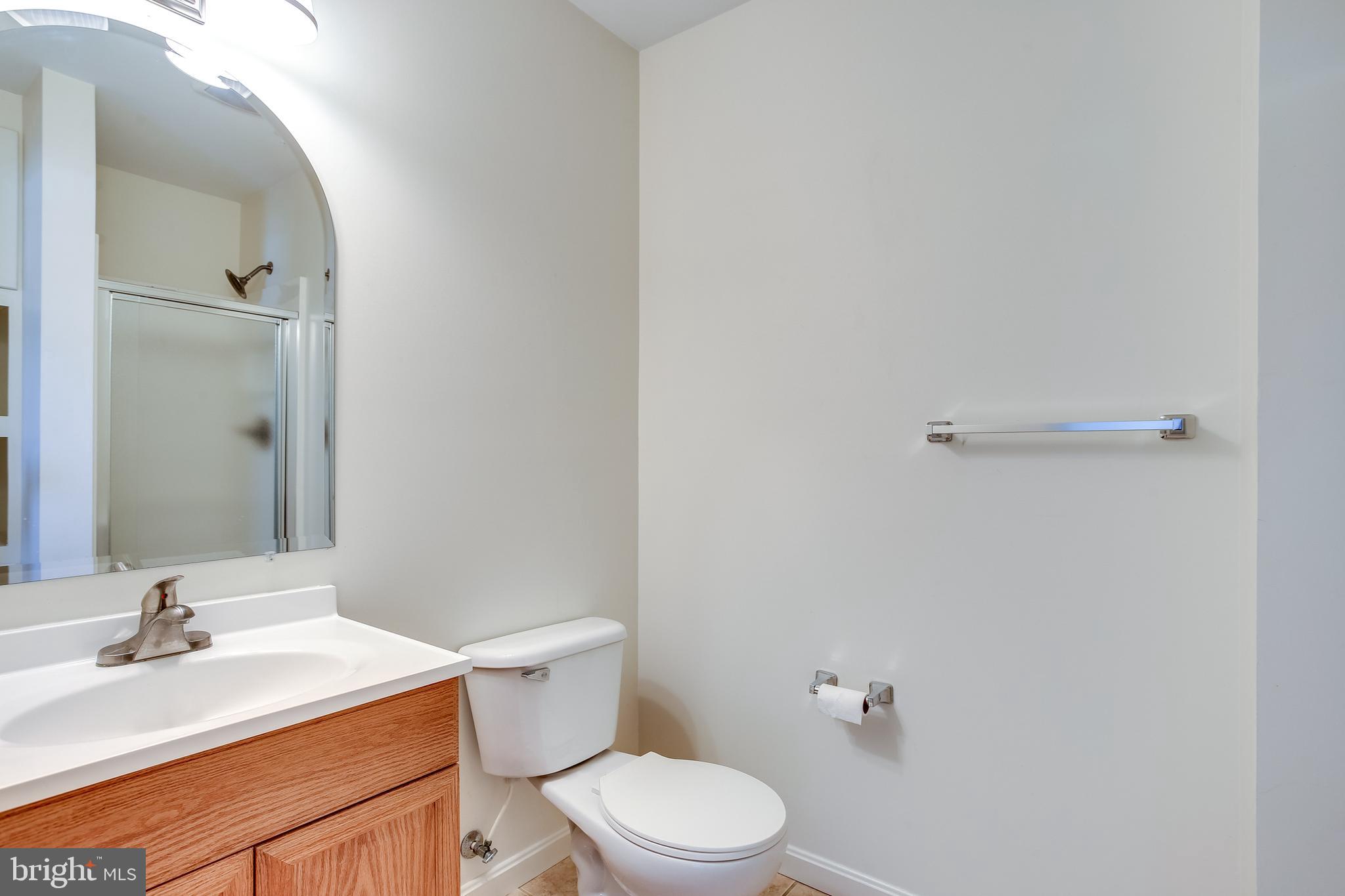 100 Penwick Circle Frederick, MD 21702 - Photo 14 of 18 a bathroom with a sink vanity mirror and toilet