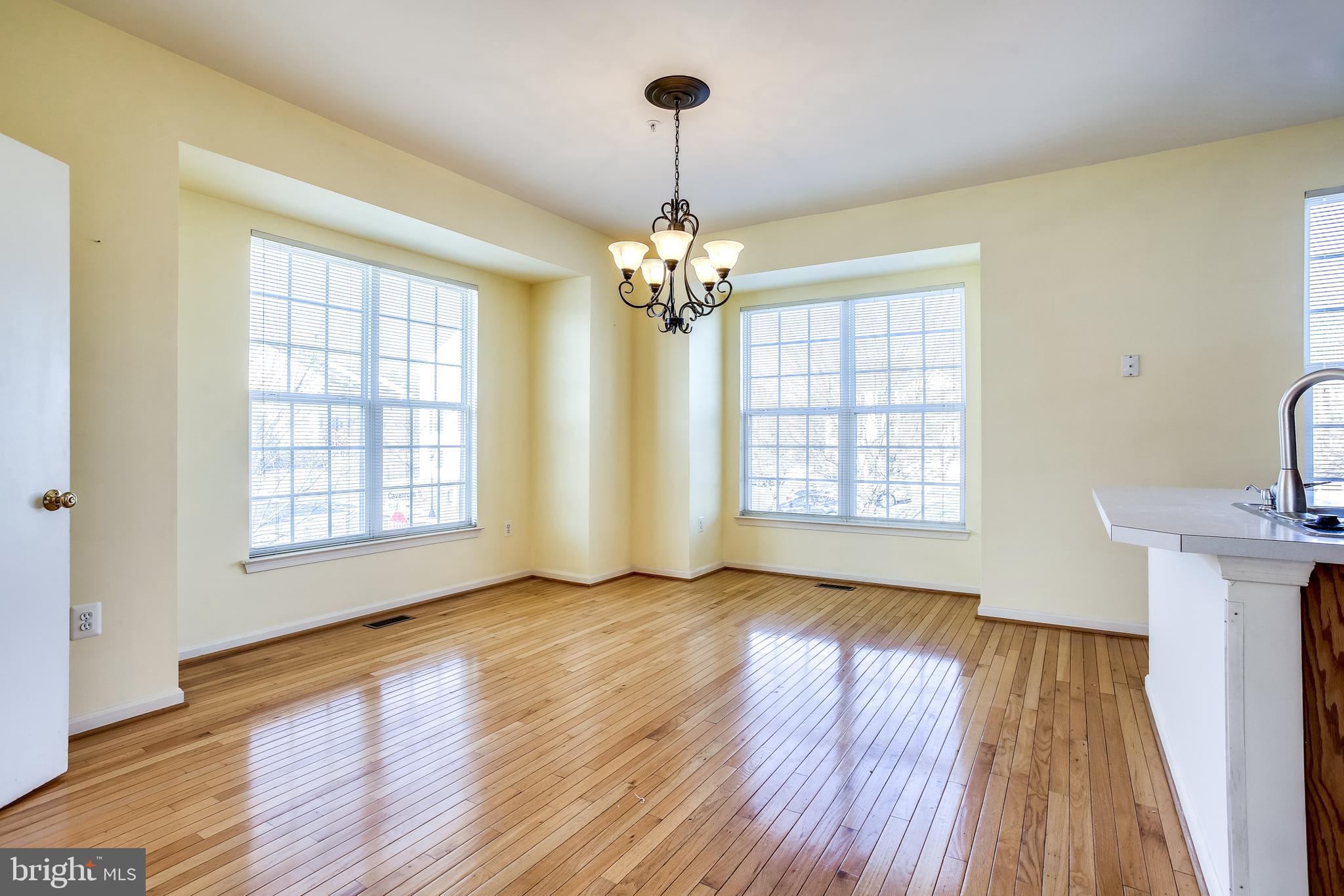 100 Penwick Circle Frederick, MD 21702 - Photo 3 of 18 a view of livingroom with window wooden floor and chandelier