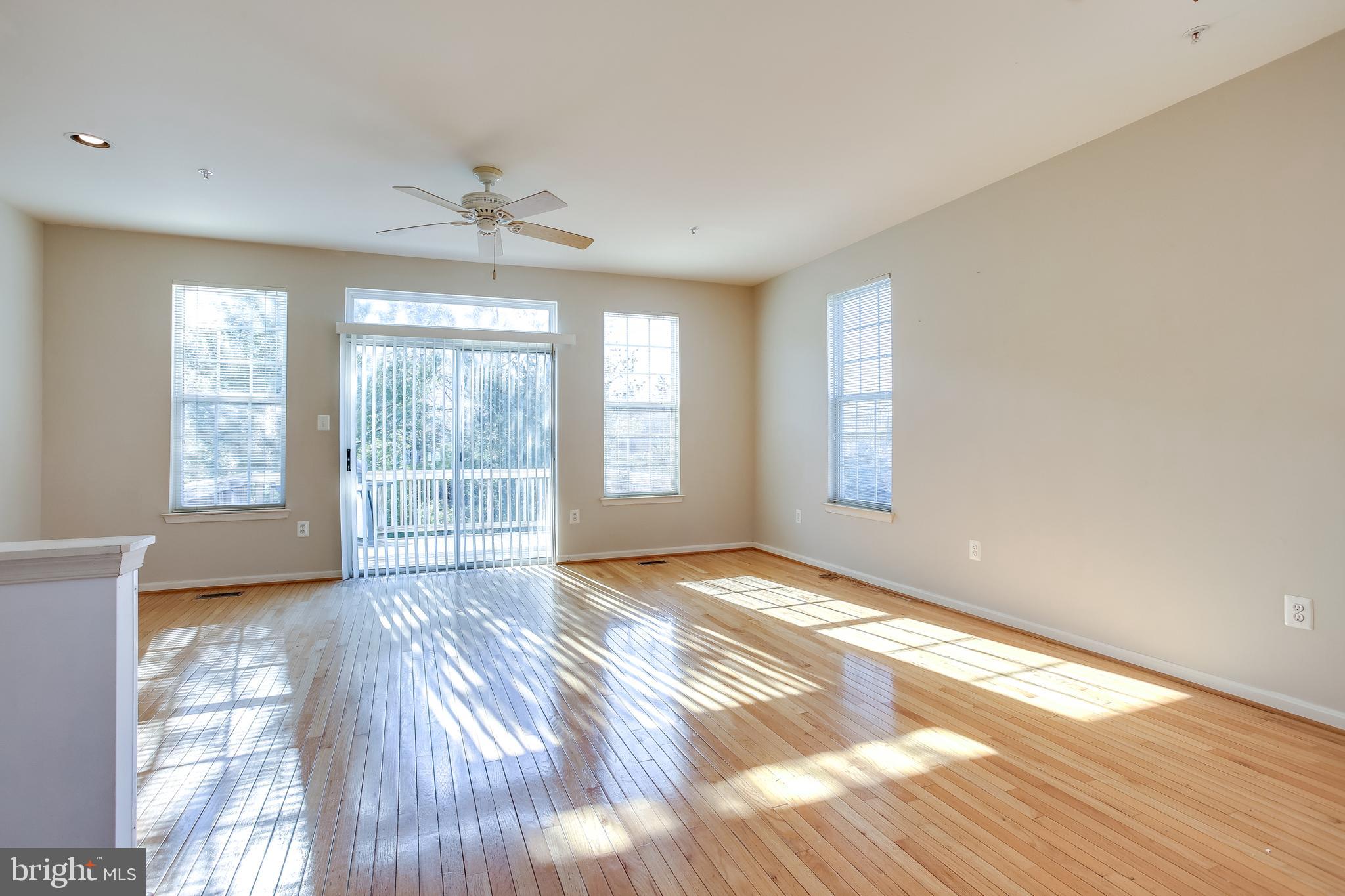 100 Penwick Circle Frederick, MD 21702 - Photo 4 of 18 a view of an empty room with a window and wooden floor