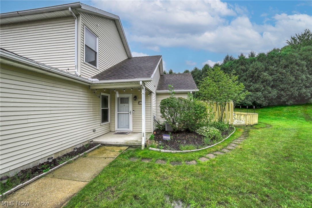 5203 Cline Road Kent, OH 44240 - Photo 26 of 35 Siding exterior with a covered front porch, concrete pathway, decorative garden bed, and a wooden deck