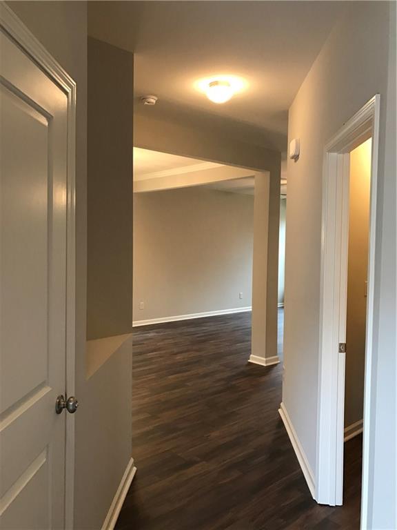 5934 Watersdown Way Flowery Branch, GA 30542 - Photo 5 of 28 a view of a hallway with wooden floor