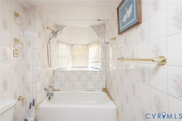 a bathroom with a bathtub and shower