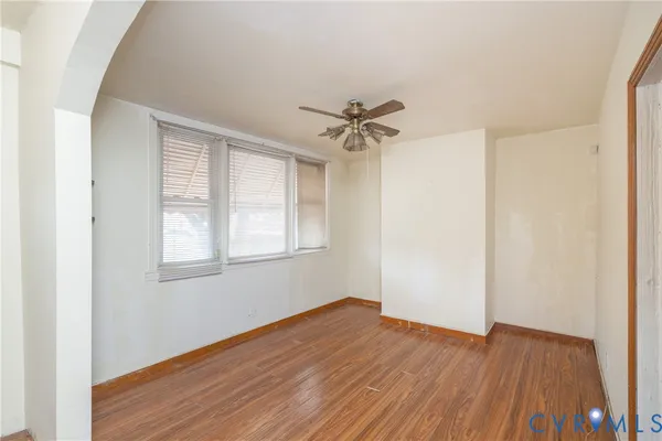 wooden floor in an empty room with a window