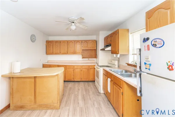 a kitchen with a sink a stove and cabinets