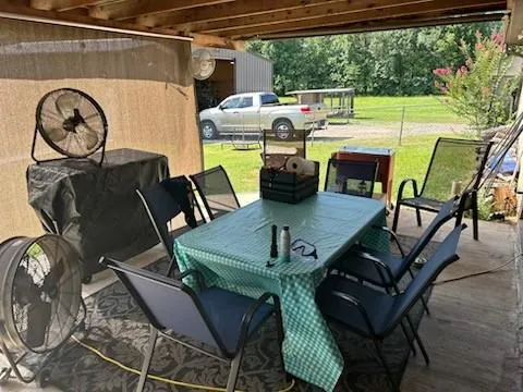 a view of a patio with table and chairs
