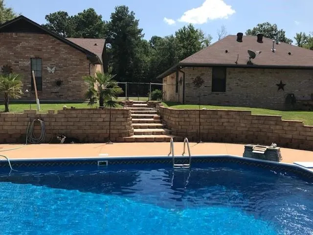 a view of backyard with wooden fence