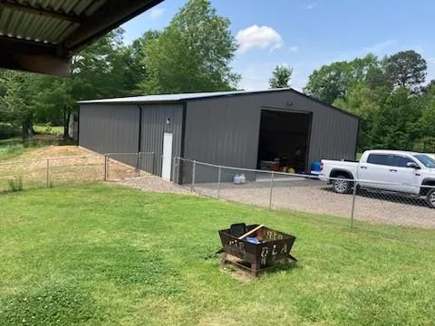 a backyard of a house with table and chairs