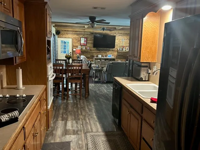 a kitchen with counter top space a sink a window and stainless steel appliances