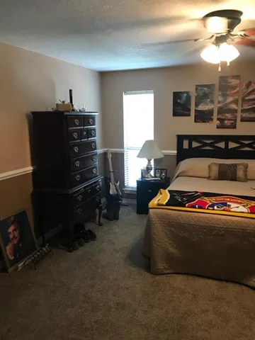 a living room with furniture and a piano