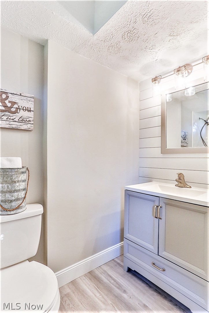 6141 Kungle Road New Franklin, OH 44216 - Photo 17 of 31 *WIDE FULL BATHROOM #2 BY REC ROOM IN LOWER LEVEL WITH CUSTOM SHIPLAP ACCENT WALL, LUXURY FLOORING, NEW VANITY, TRIPLE SCONCE LIGHTING AND WALK IN SHOWER!
