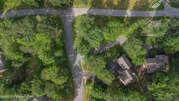 an aerial view of a house with outdoor space pool seating area and yard