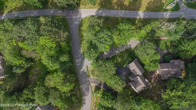 an aerial view of a house with outdoor space pool seating area and yard