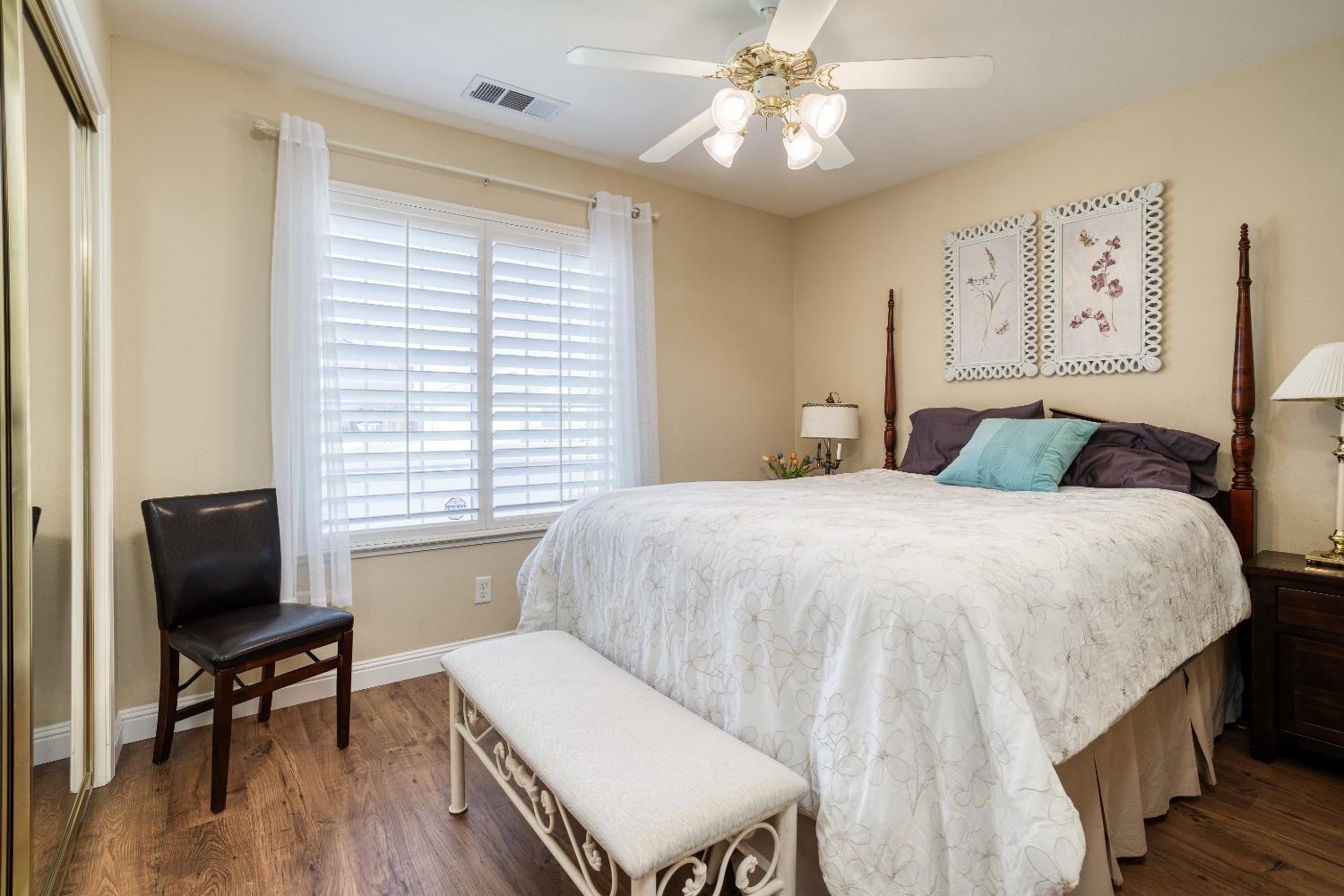 1950 Lawrence Avenue Clovis, CA 93611 - Photo 11 of 23 a bedroom with a bed and a chair