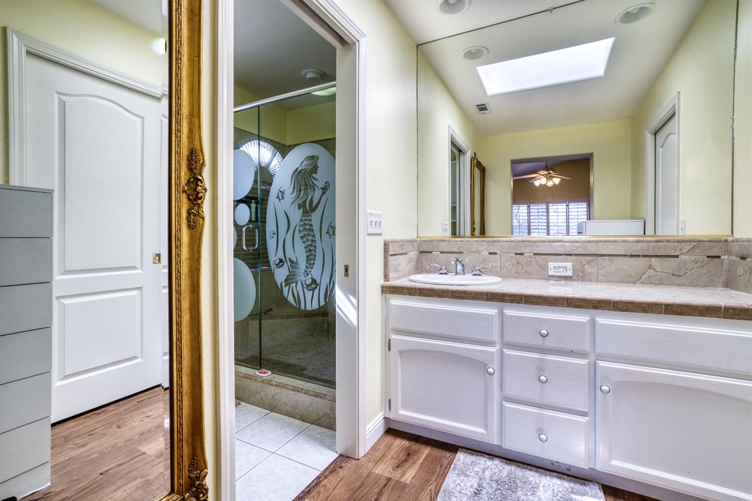 1950 Lawrence Avenue Clovis, CA 93611 - Photo 13 of 23 a bathroom with a granite countertop sink mirror and vanity