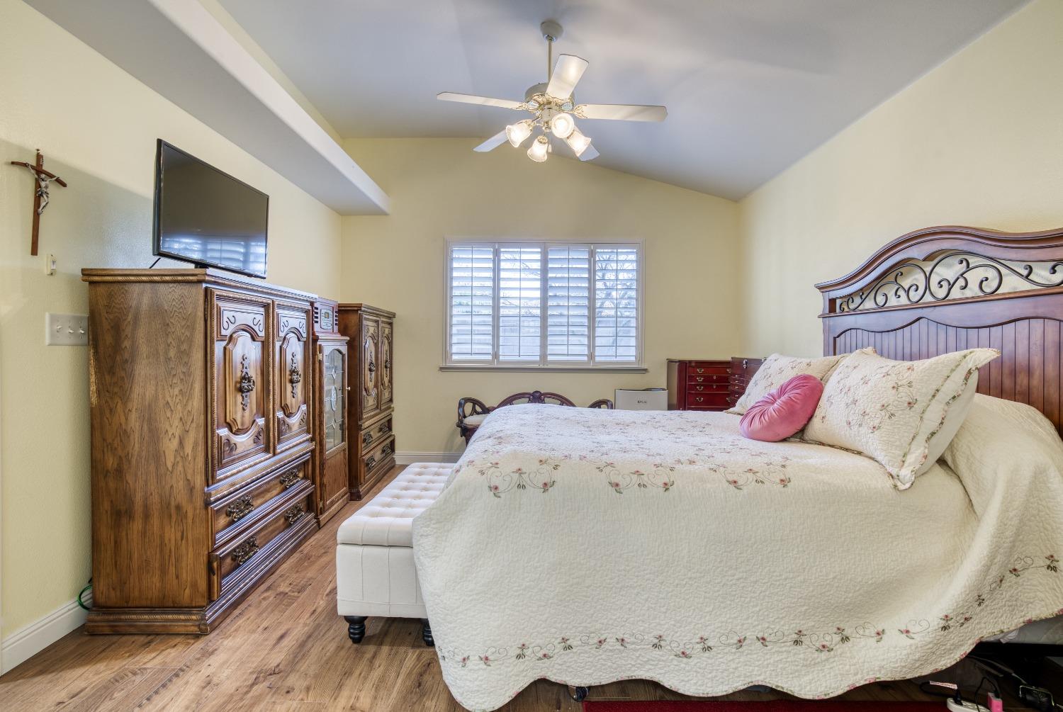 1950 Lawrence Avenue Clovis, CA 93611 - Photo 15 of 23 a bedroom with a bed and wooden floor