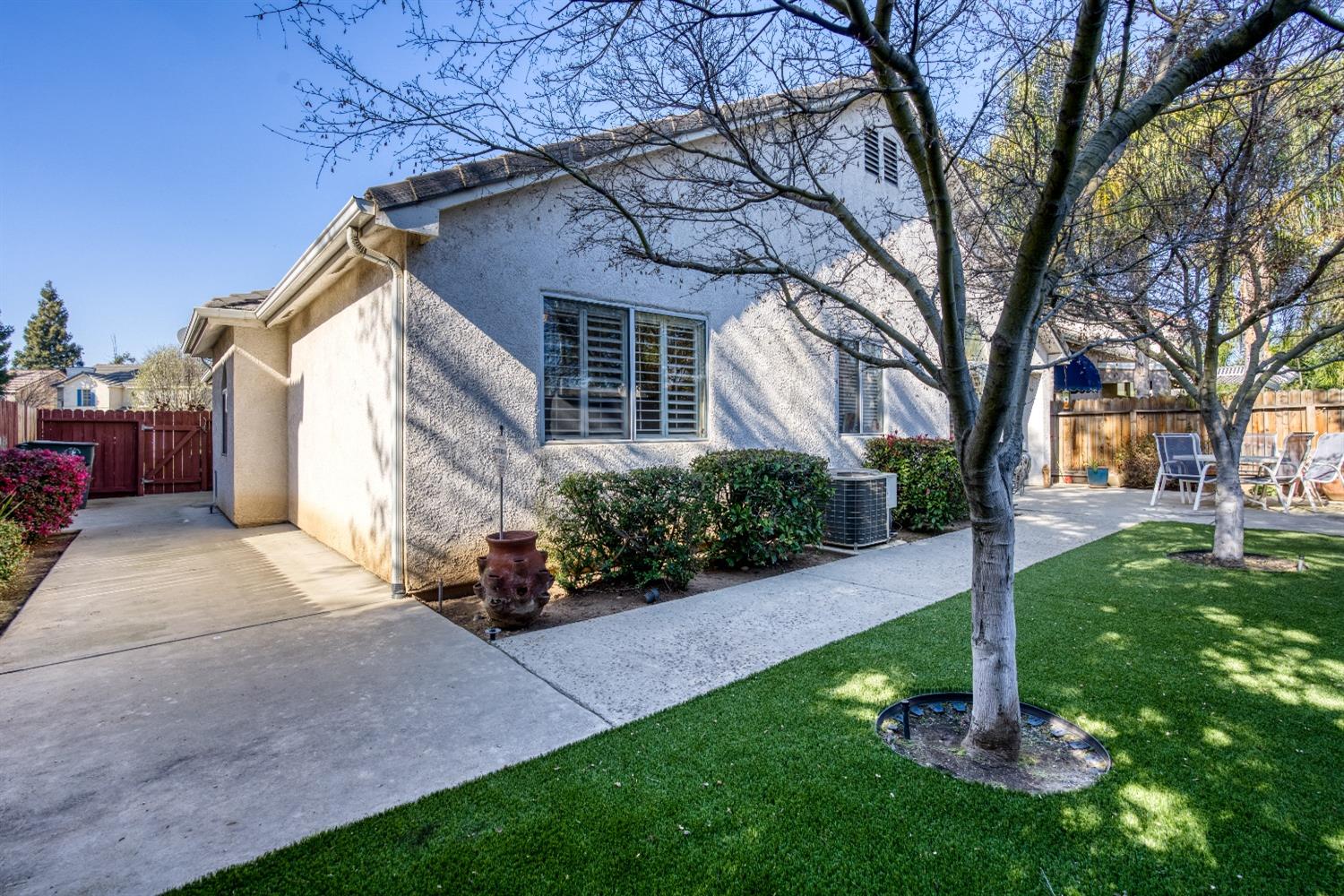 1950 Lawrence Avenue Clovis, CA 93611 - Photo 17 of 23 a front view of a house with a garden and trees