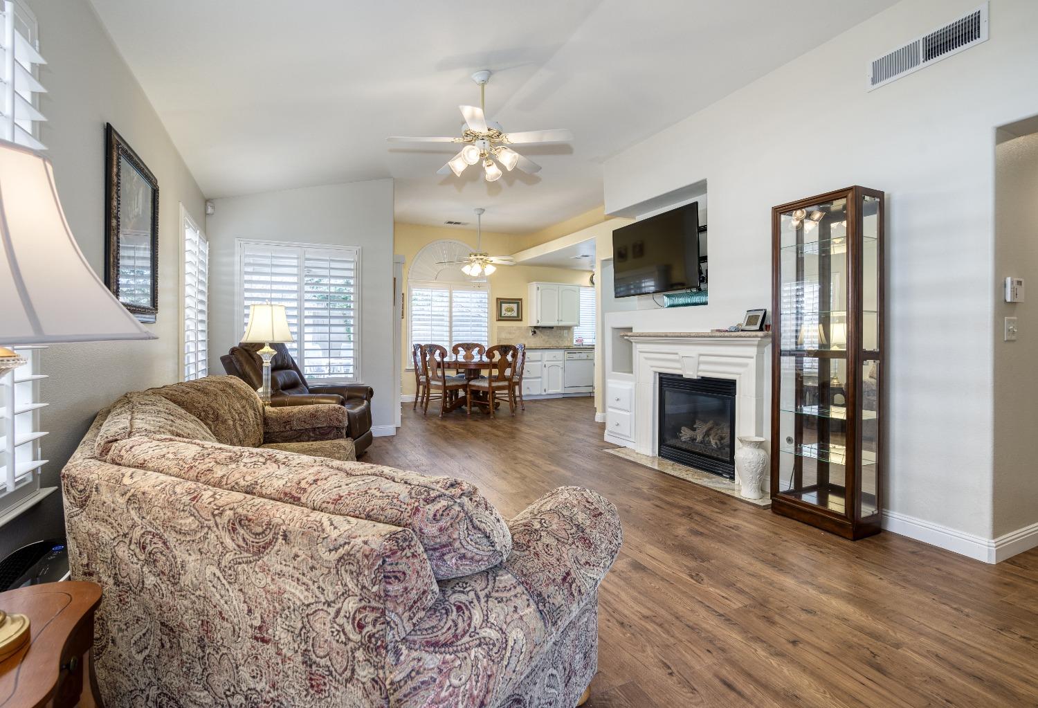 1950 Lawrence Avenue Clovis, CA 93611 - Photo 2 of 23 a living room with furniture a flat screen tv and a fireplace