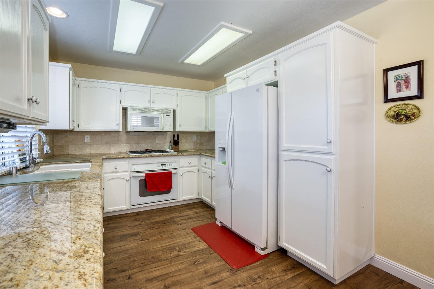 1950 Lawrence Avenue Clovis, CA 93611 - Photo 5 of 23 a kitchen with stainless steel appliances granite countertop a refrigerator sink and stove