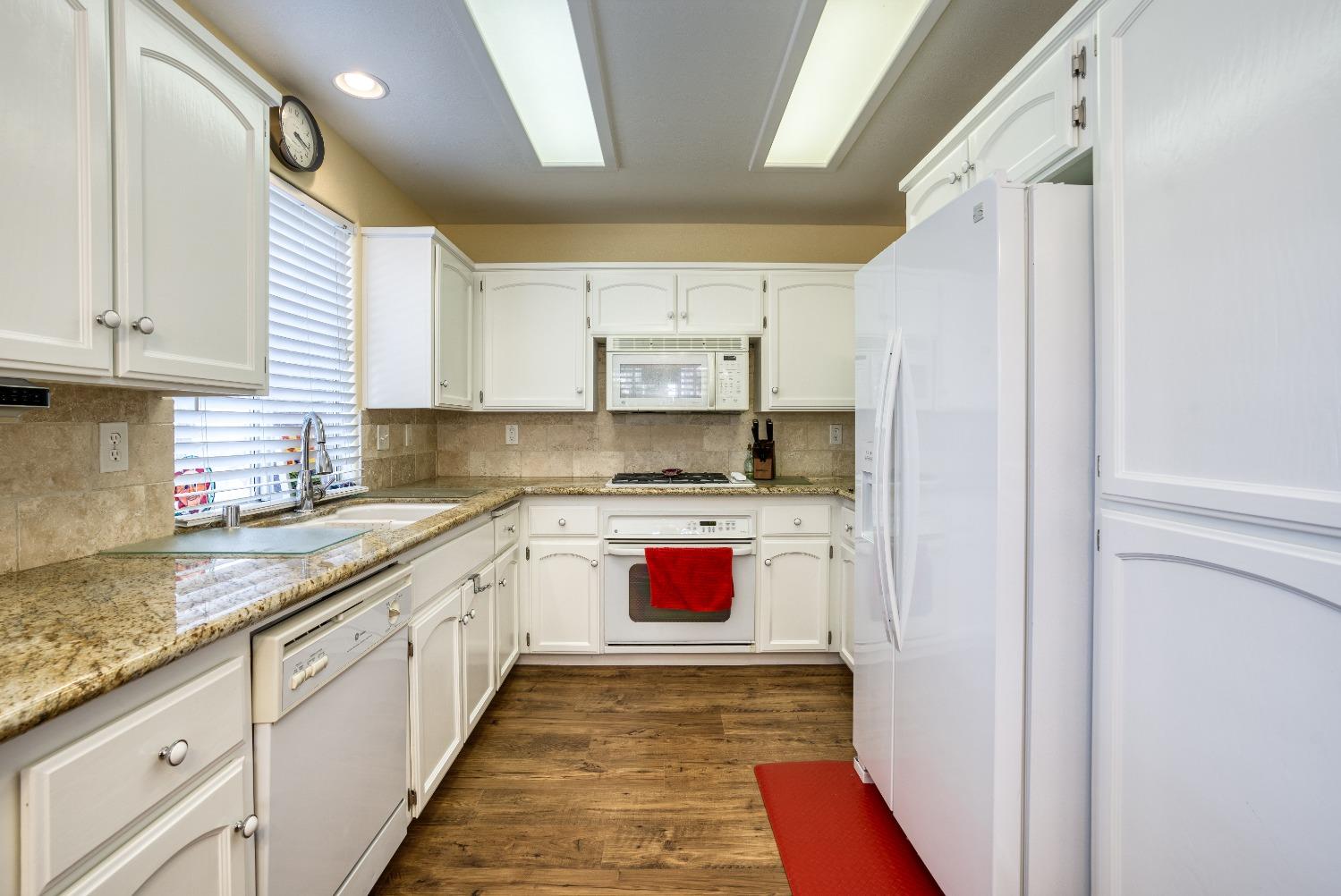 1950 Lawrence Avenue Clovis, CA 93611 - Photo 6 of 23 a kitchen with stainless steel appliances granite countertop a sink and a stove