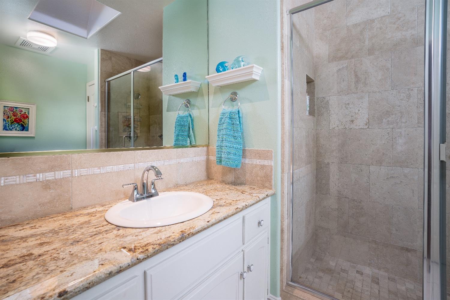 1950 Lawrence Avenue Clovis, CA 93611 - Photo 9 of 23 a bathroom with a granite countertop sink and a mirror