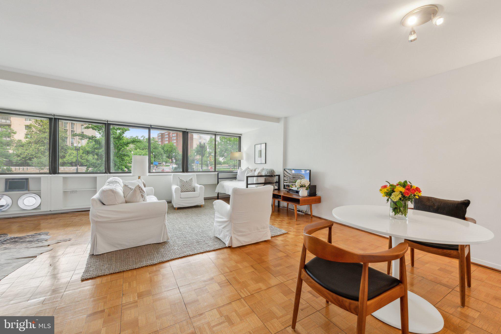 2510 Virginia Avenue Northwest, Unit 2BN Washington, DC 20037 - Photo 11 of 21 a living room with furniture and a floor to ceiling window