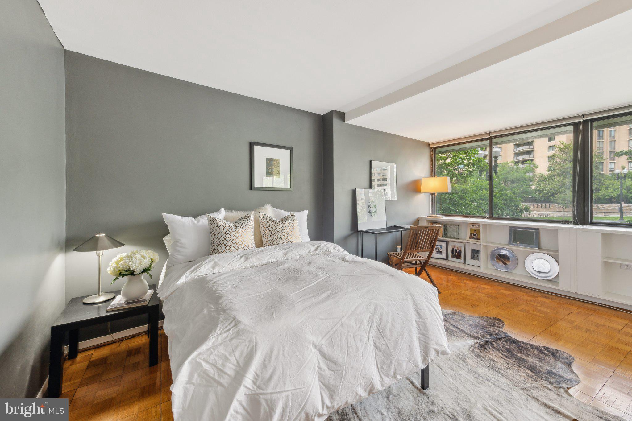 2510 Virginia Avenue Northwest, Unit 2BN Washington, DC 20037 - Photo 12 of 21 a large bedroom with a bed and large windows