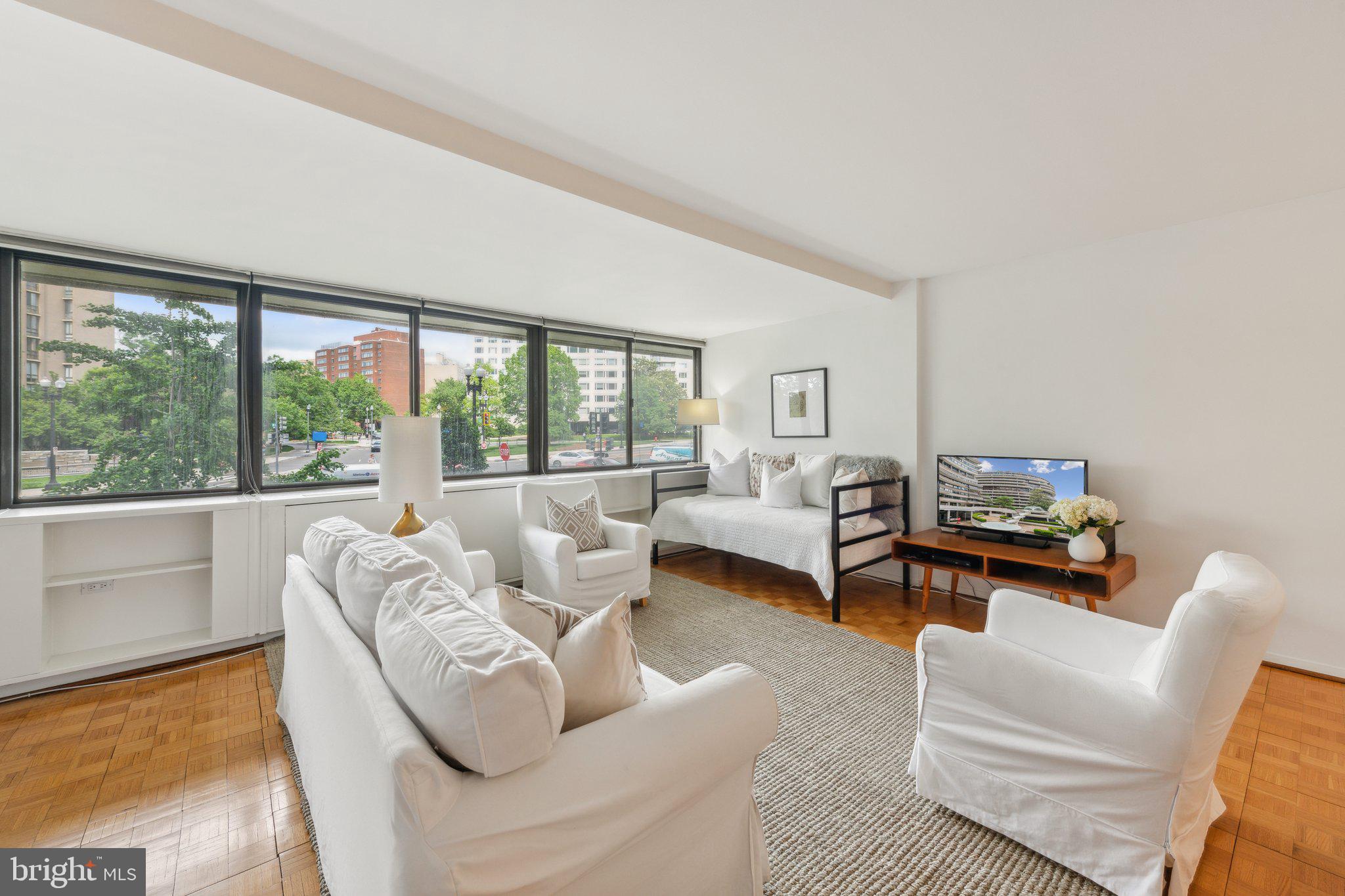 2510 Virginia Avenue Northwest, Unit 2BN Washington, DC 20037 - Photo 13 of 21 a living room with furniture and a large window