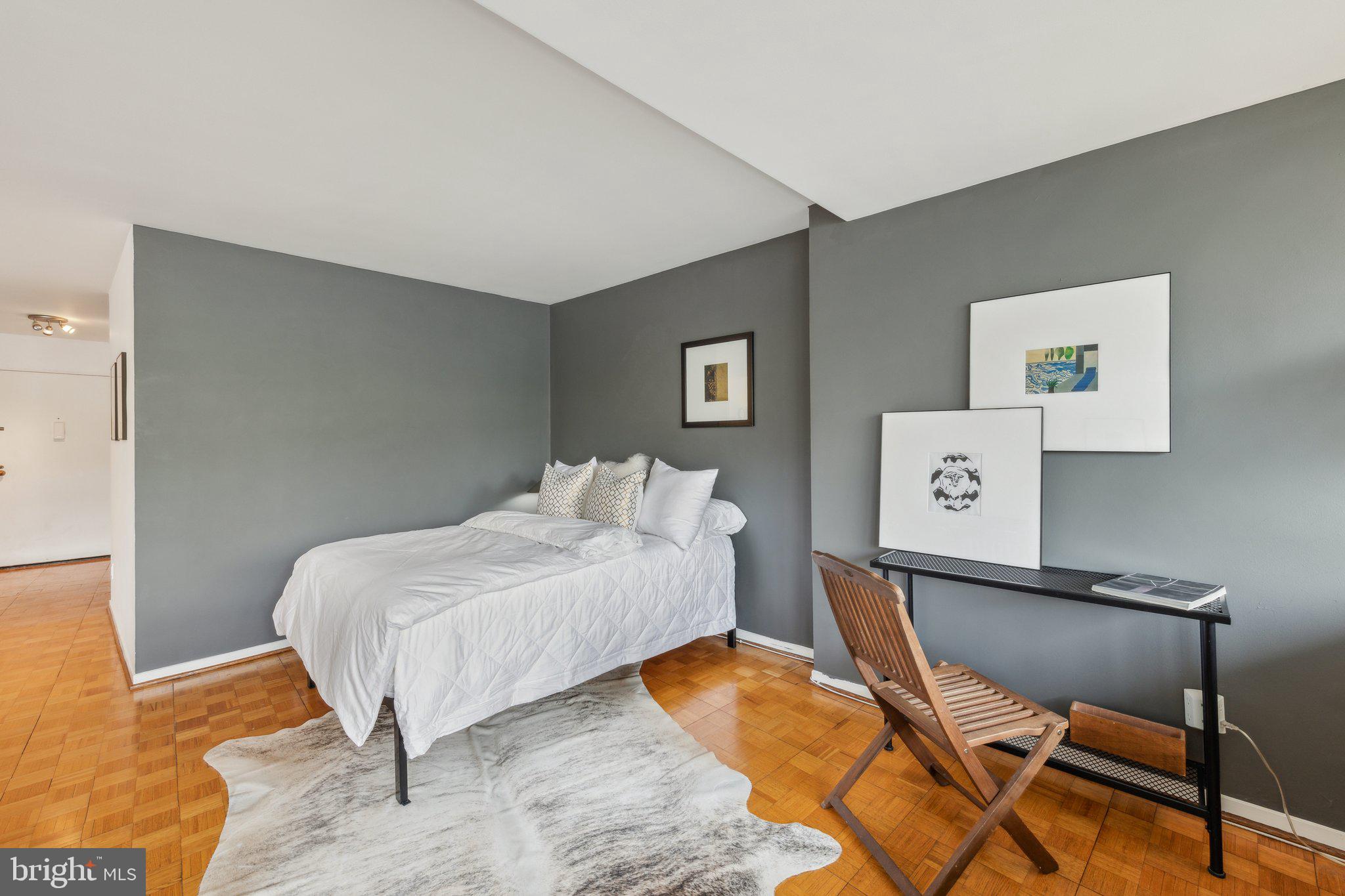 2510 Virginia Avenue Northwest, Unit 2BN Washington, DC 20037 - Photo 14 of 21 a bedroom with a bed and a table in it