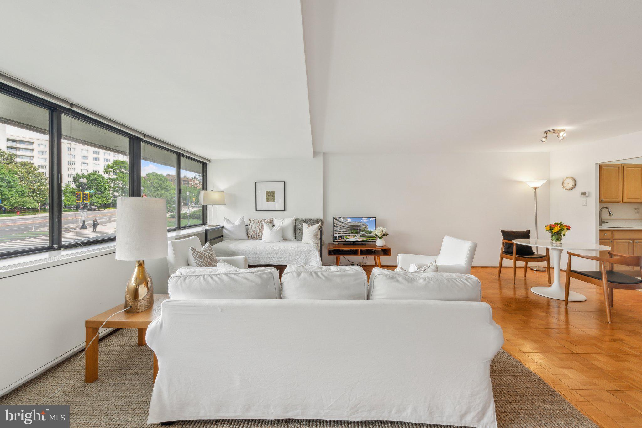 2510 Virginia Avenue Northwest, Unit 2BN Washington, DC 20037 - Photo 15 of 21 a living room with fireplace furniture and a large window