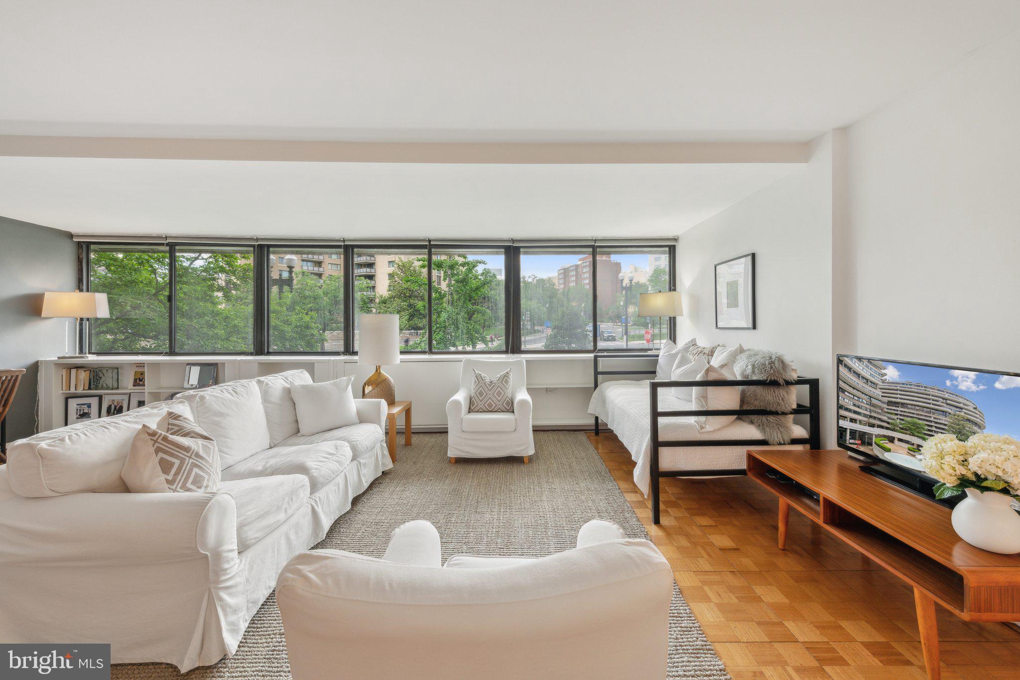 2510 Virginia Avenue Northwest, Unit 2BN Washington, DC 20037 - Photo 17 of 21 a living room with furniture and a floor to ceiling window