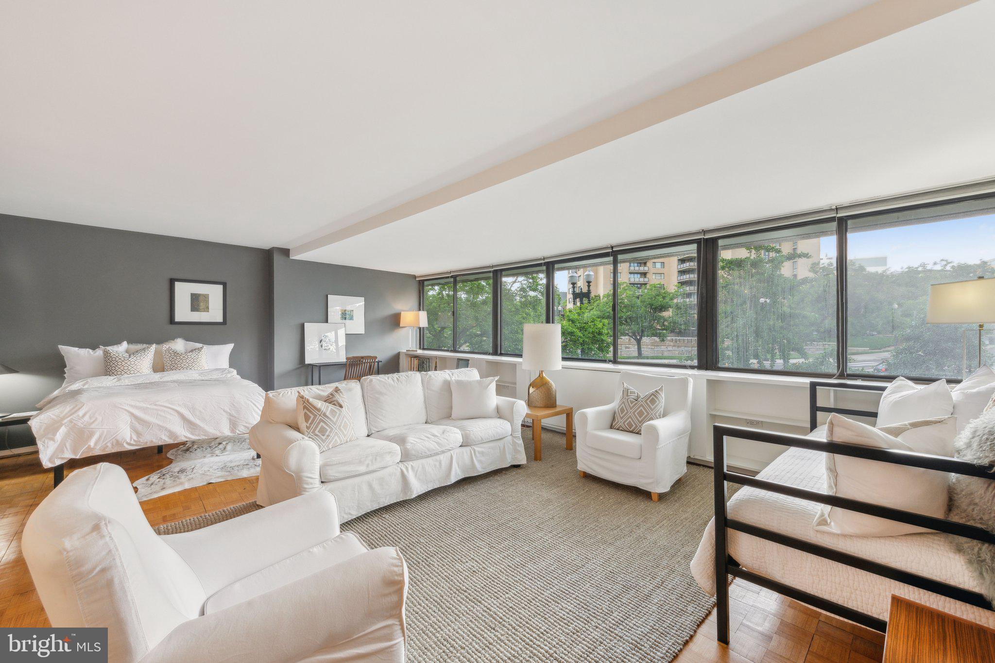 2510 Virginia Avenue Northwest, Unit 2BN Washington, DC 20037 - Photo 2 of 21 a living room with furniture and a large window
