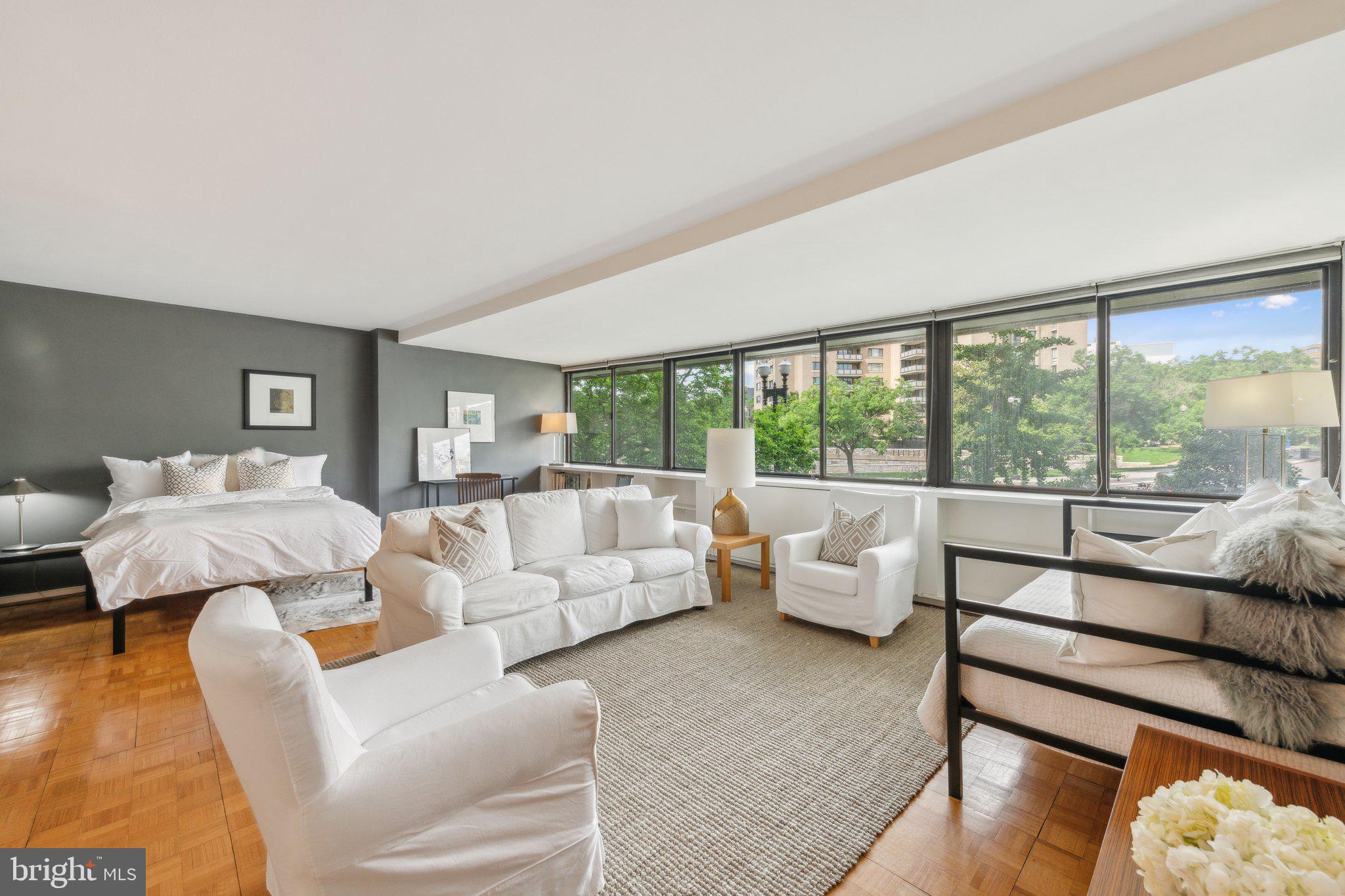 2510 Virginia Avenue Northwest, Unit 2BN Washington, DC 20037 - Photo 3 of 21 a living room with furniture and a large window