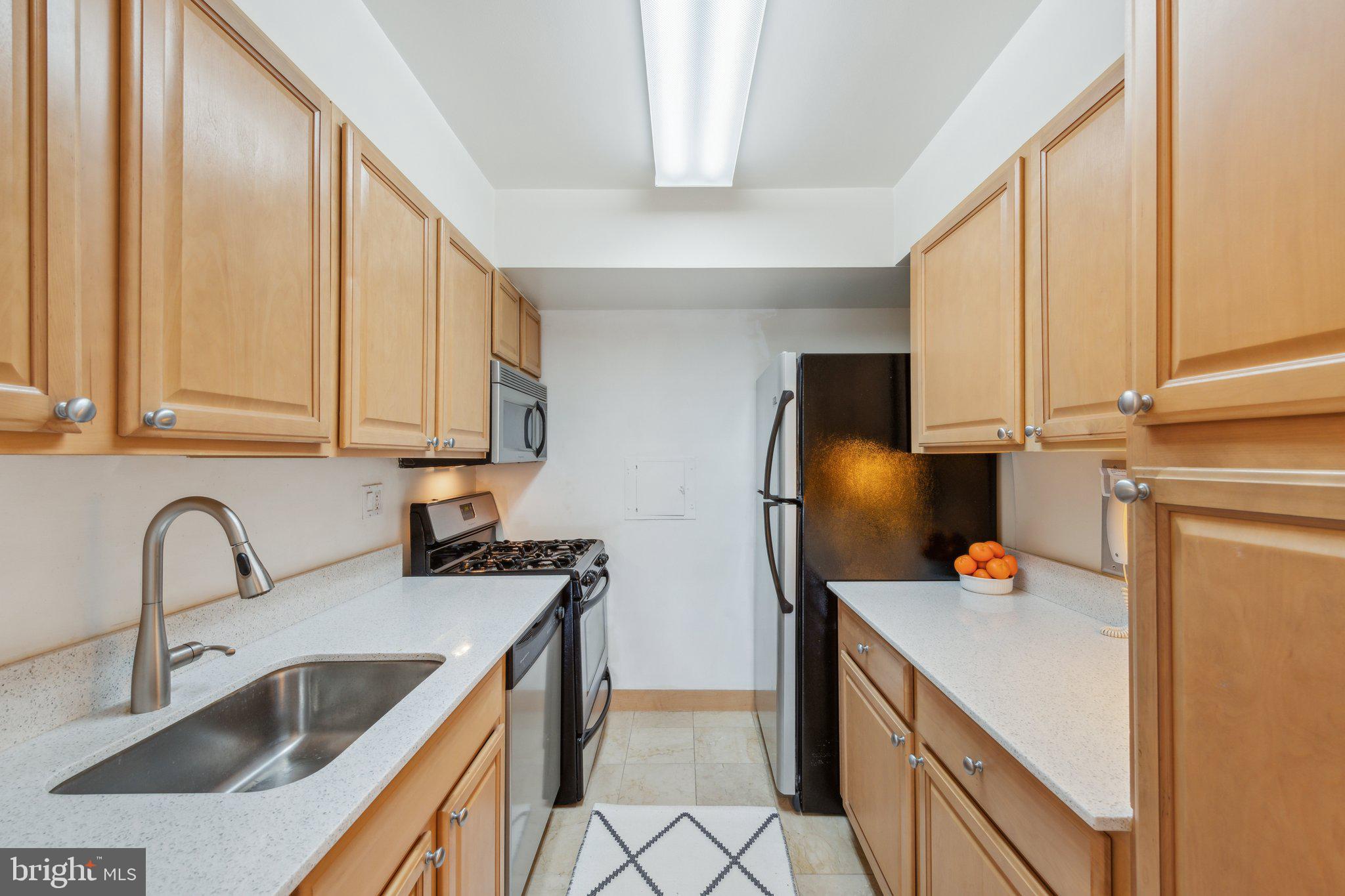2510 Virginia Avenue Northwest, Unit 2BN Washington, DC 20037 - Photo 6 of 21 a kitchen with stainless steel appliances a sink a stove and a refrigerator