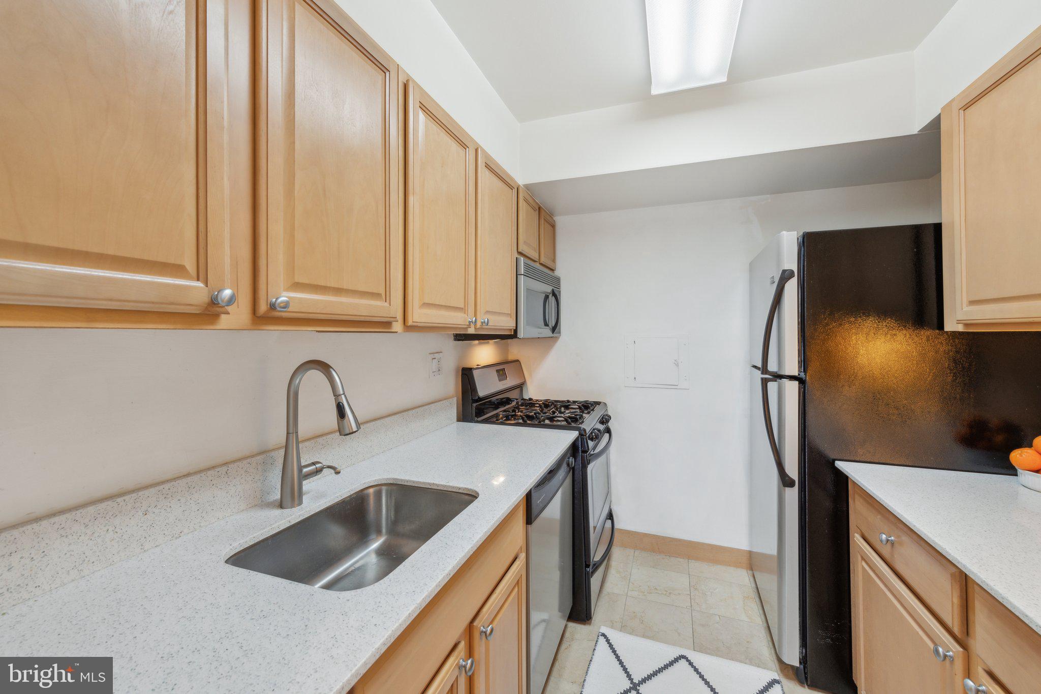 2510 Virginia Avenue Northwest, Unit 2BN Washington, DC 20037 - Photo 7 of 21 a kitchen with stainless steel appliances a sink stove and refrigerator