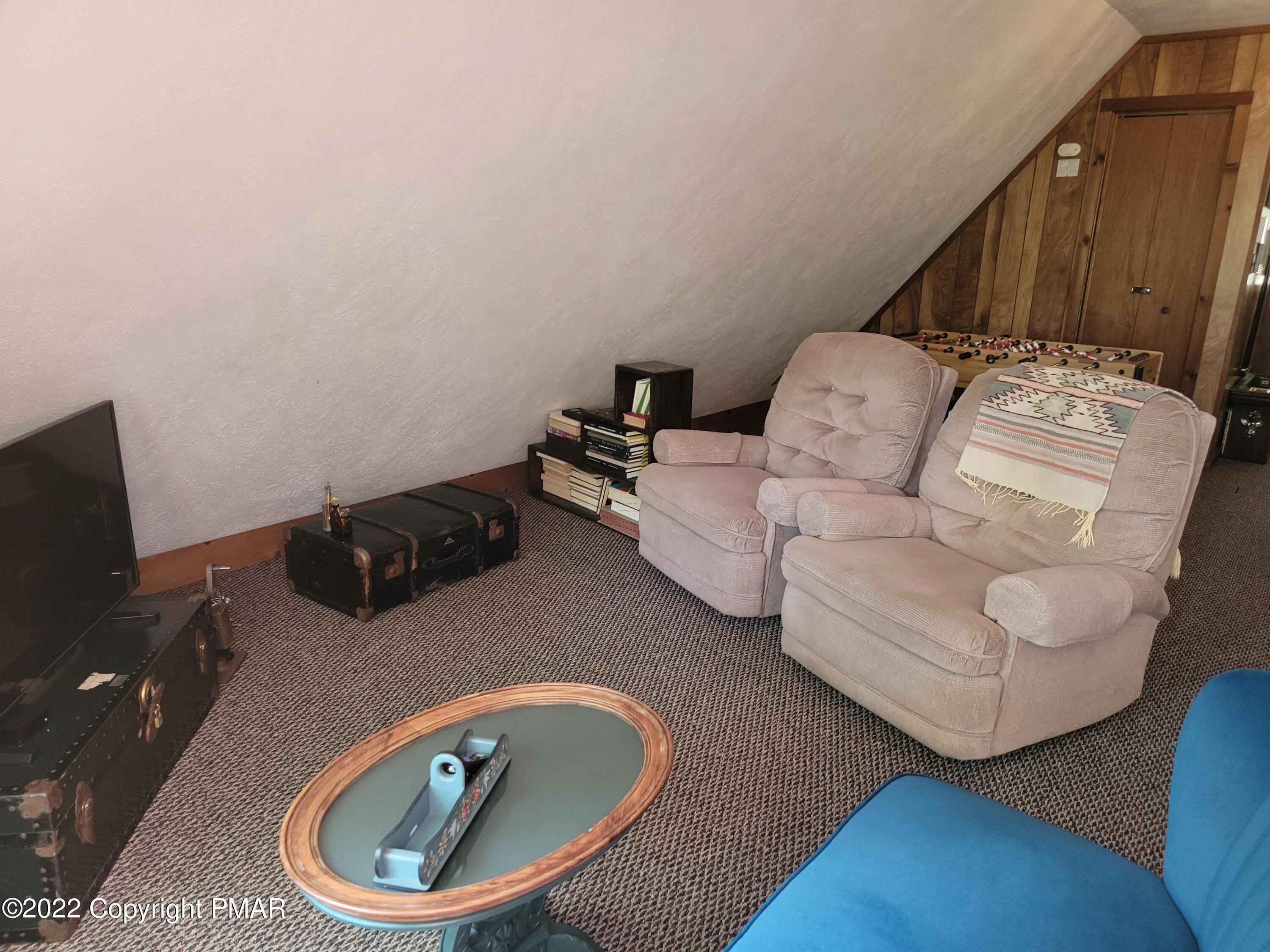 358 Brentwood Drive Bushkill, PA 18324 - Photo 16 of 59 a living room with furniture and a flat screen tv