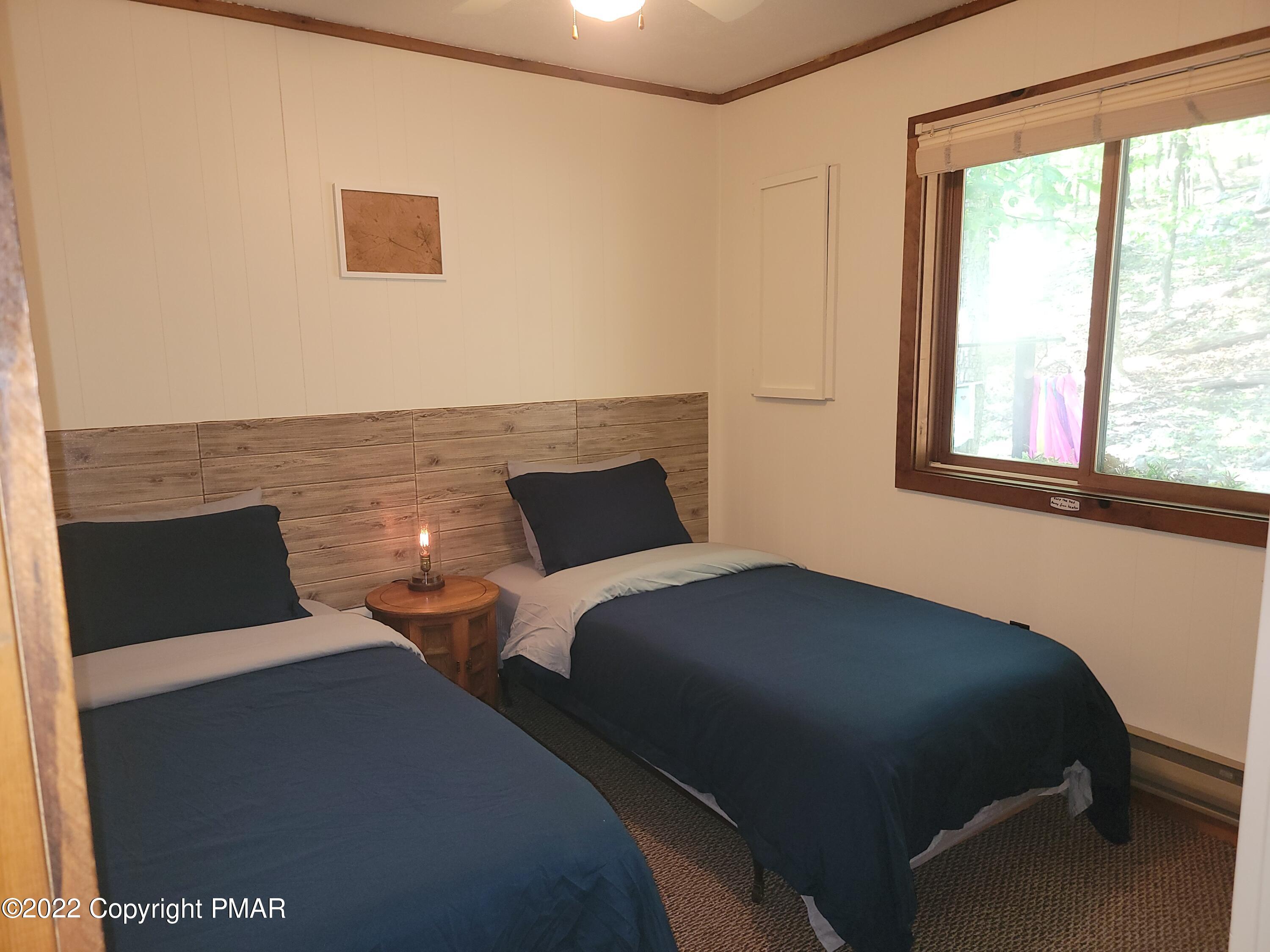 358 Brentwood Drive Bushkill, PA 18324 - Photo 19 of 59 a bedroom with two beds and a window