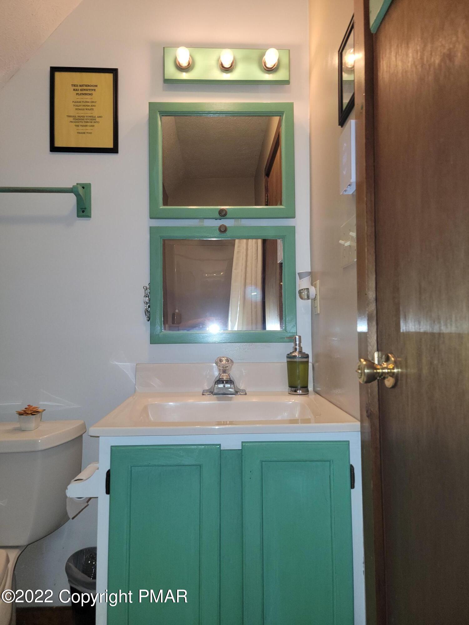 358 Brentwood Drive Bushkill, PA 18324 - Photo 21 of 59 a bathroom with a toilet sink and mirror