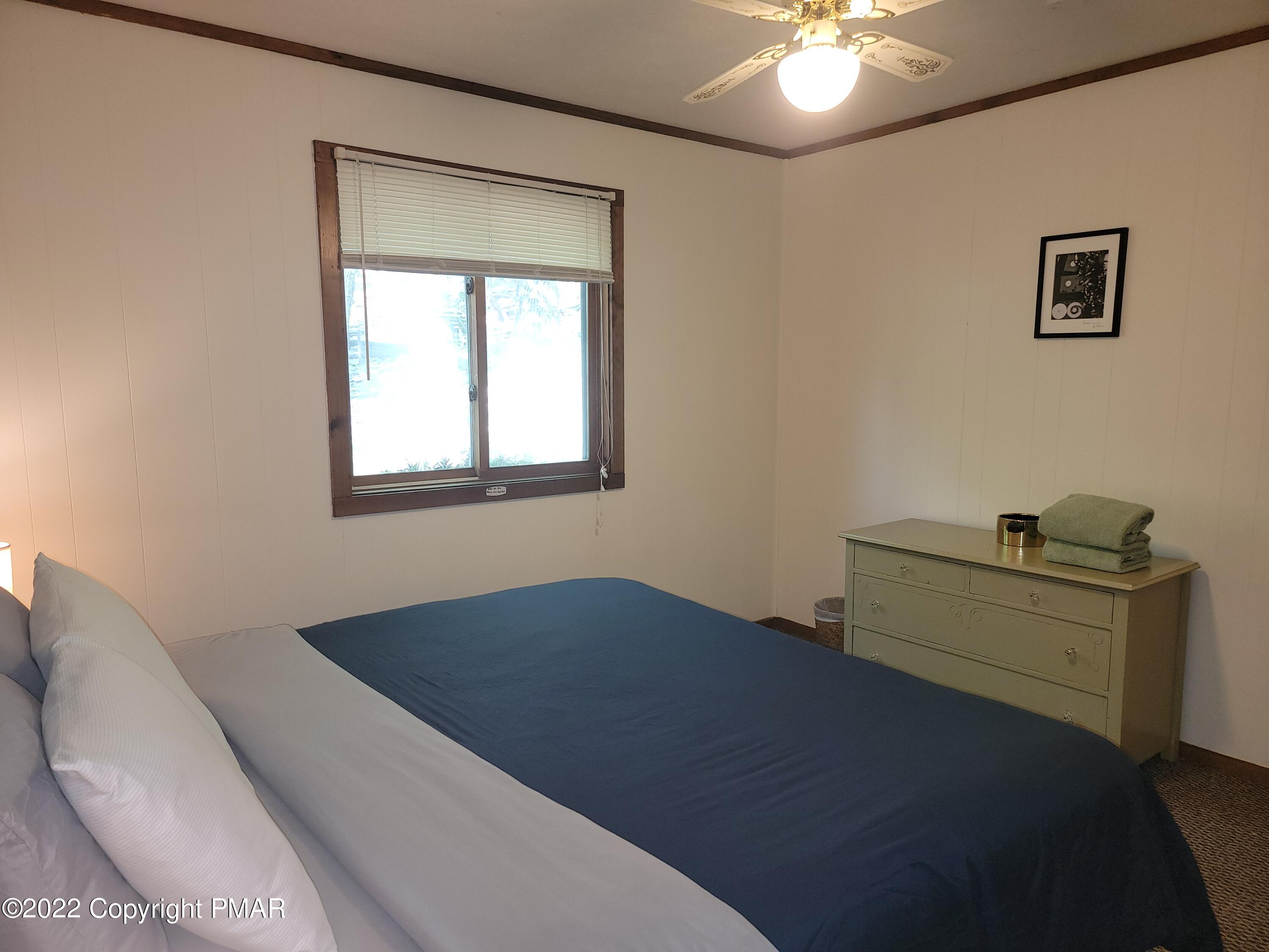 358 Brentwood Drive Bushkill, PA 18324 - Photo 24 of 59 a bedroom with a bed and a chandelier