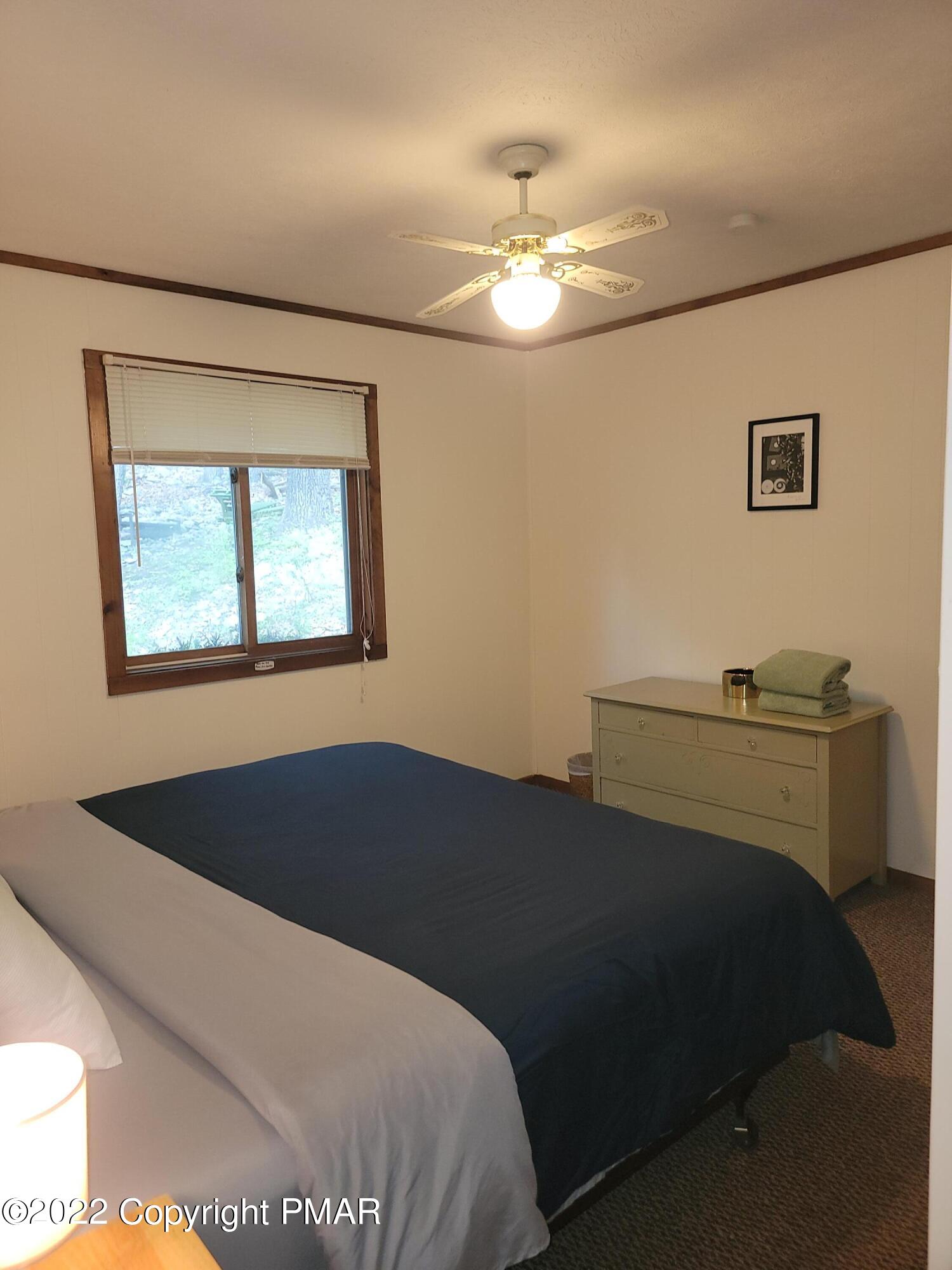 358 Brentwood Drive Bushkill, PA 18324 - Photo 26 of 59 a bedroom with a bed and a chandelier