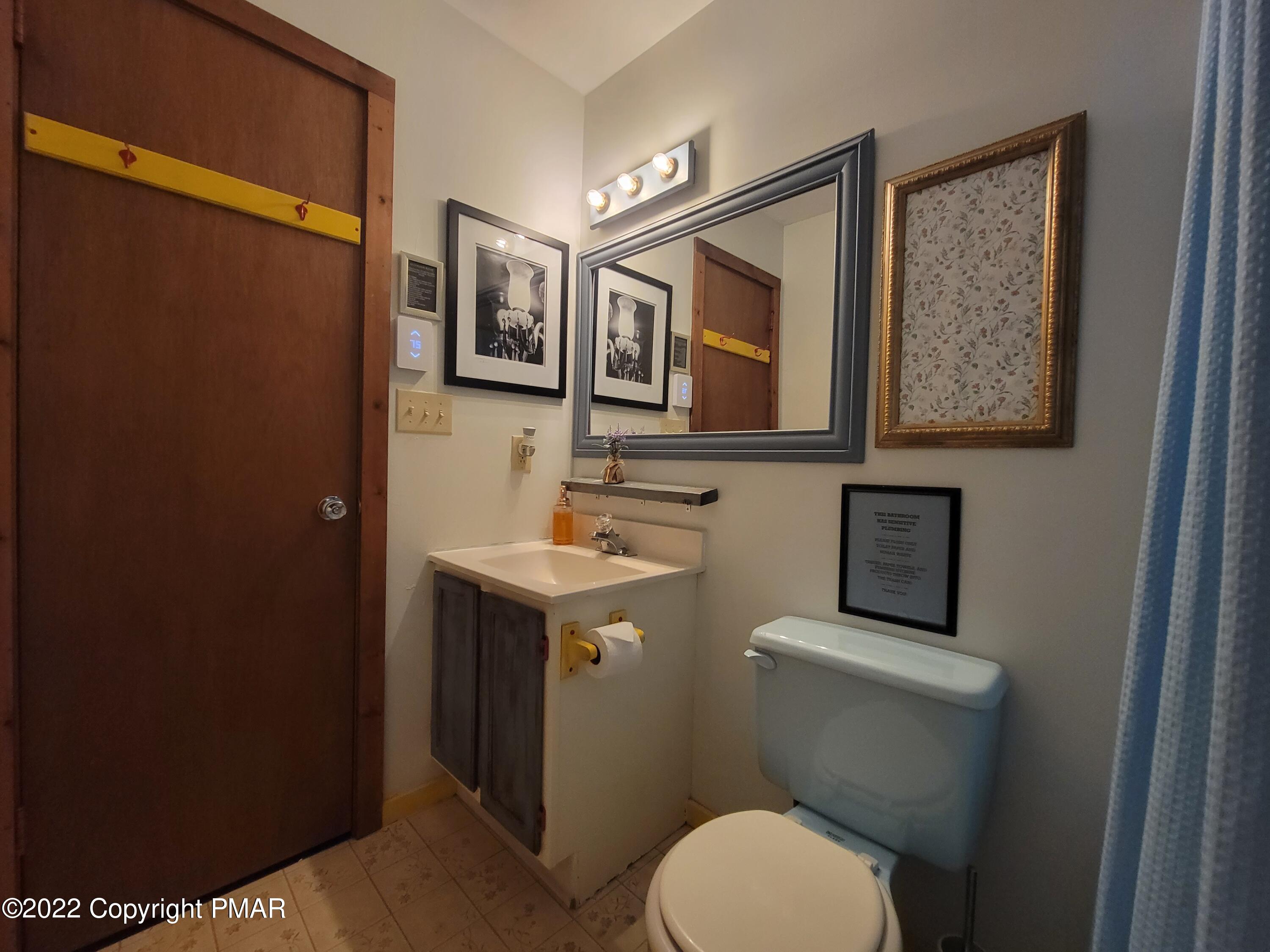 358 Brentwood Drive Bushkill, PA 18324 - Photo 28 of 59 a bathroom with a toilet a sink and mirror