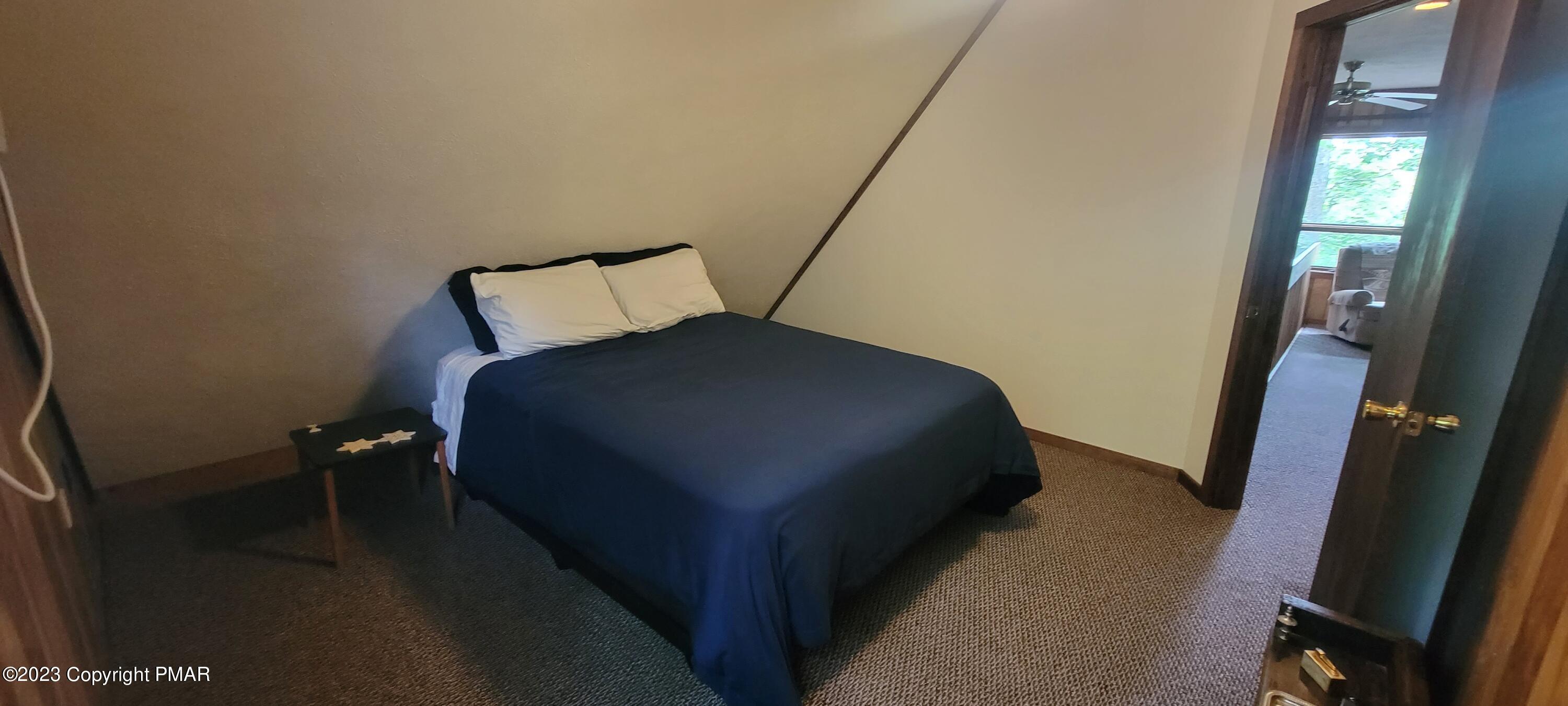 358 Brentwood Drive Bushkill, PA 18324 - Photo 30 of 59 a bedroom with a bed and a mirror