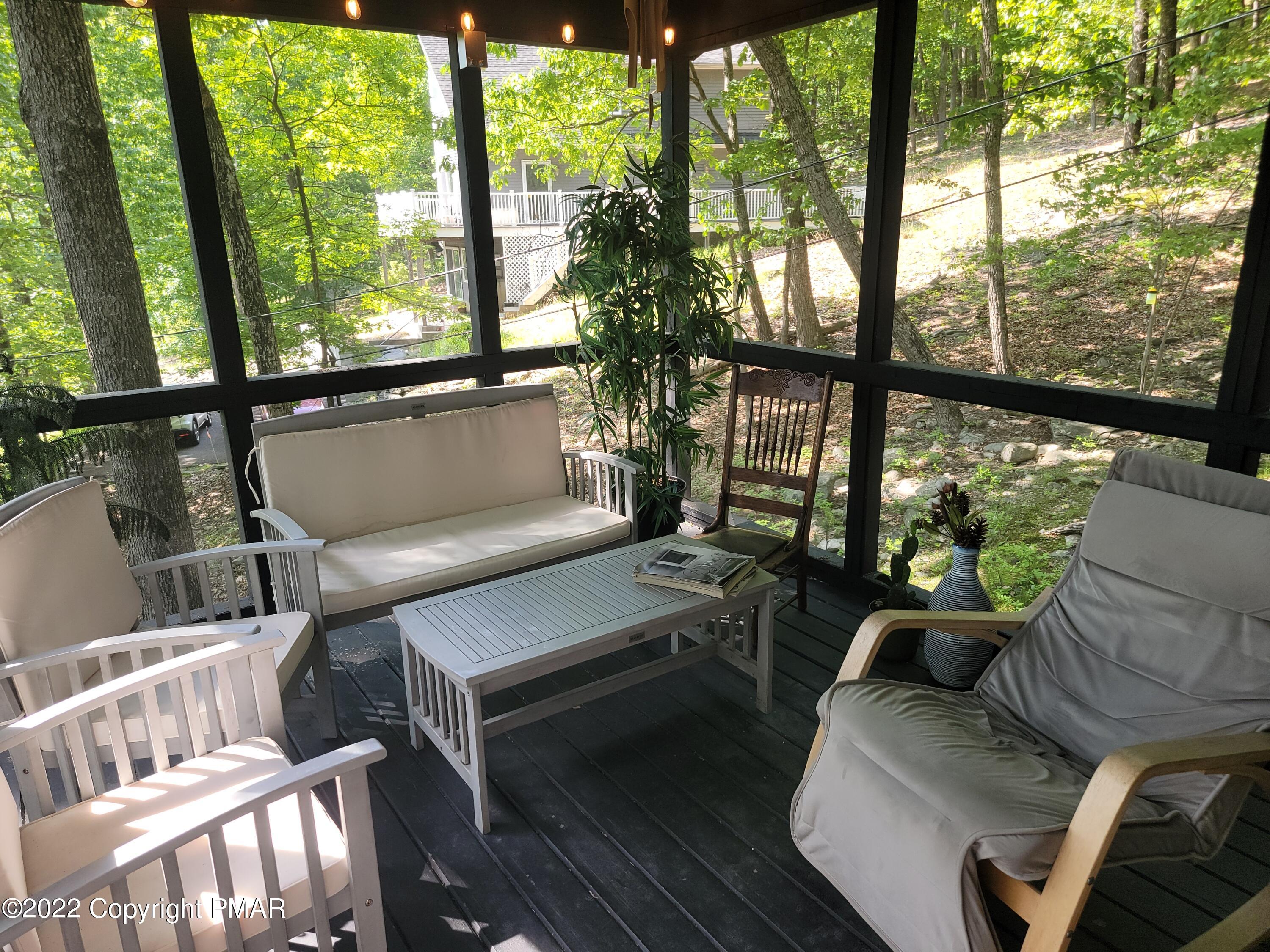 358 Brentwood Drive Bushkill, PA 18324 - Photo 33 of 59 a living room with furniture and a floor to ceiling window