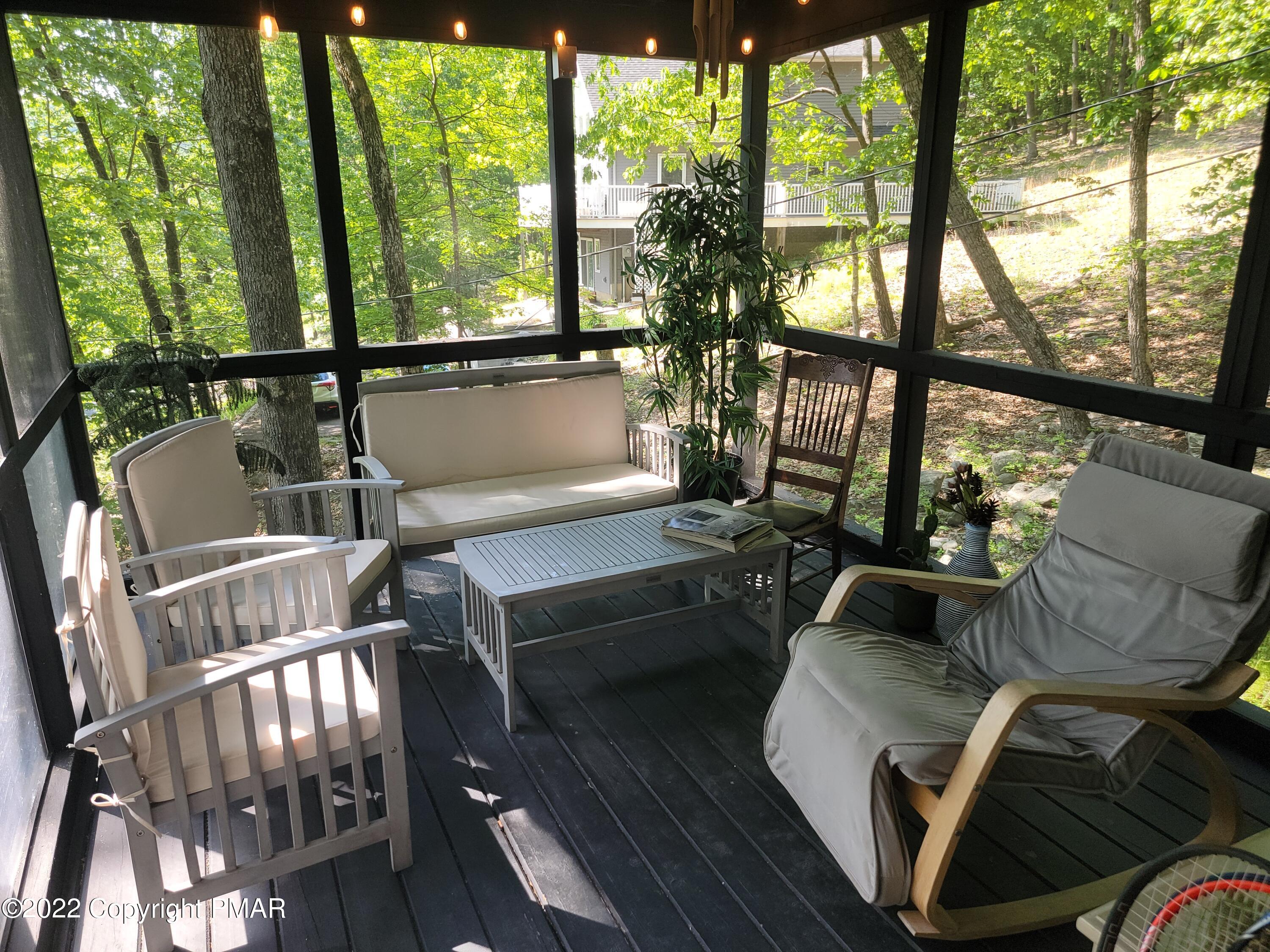 358 Brentwood Drive Bushkill, PA 18324 - Photo 34 of 59 a living room with furniture and a floor to ceiling window