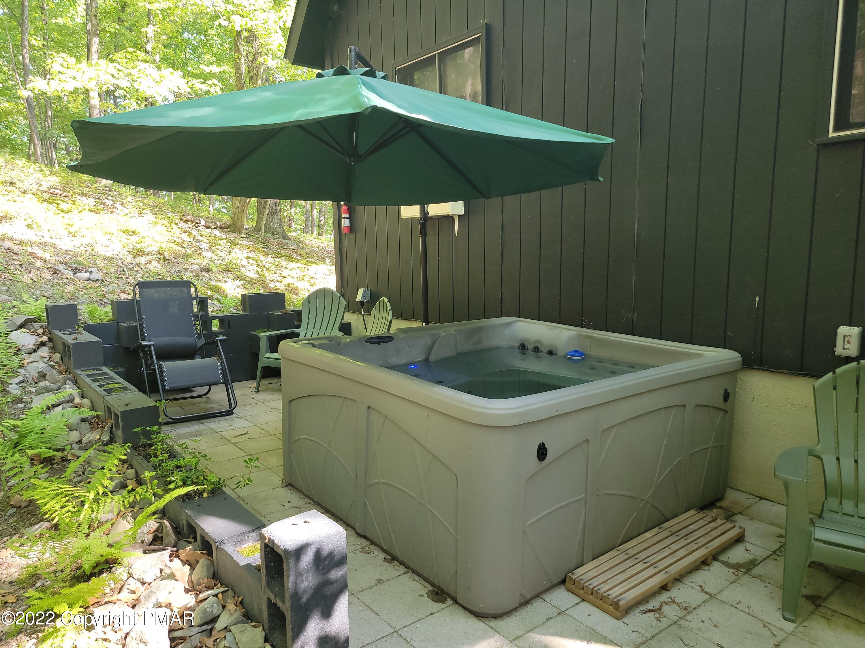 358 Brentwood Drive Bushkill, PA 18324 - Photo 35 of 59 a backyard of a house with table and chairs