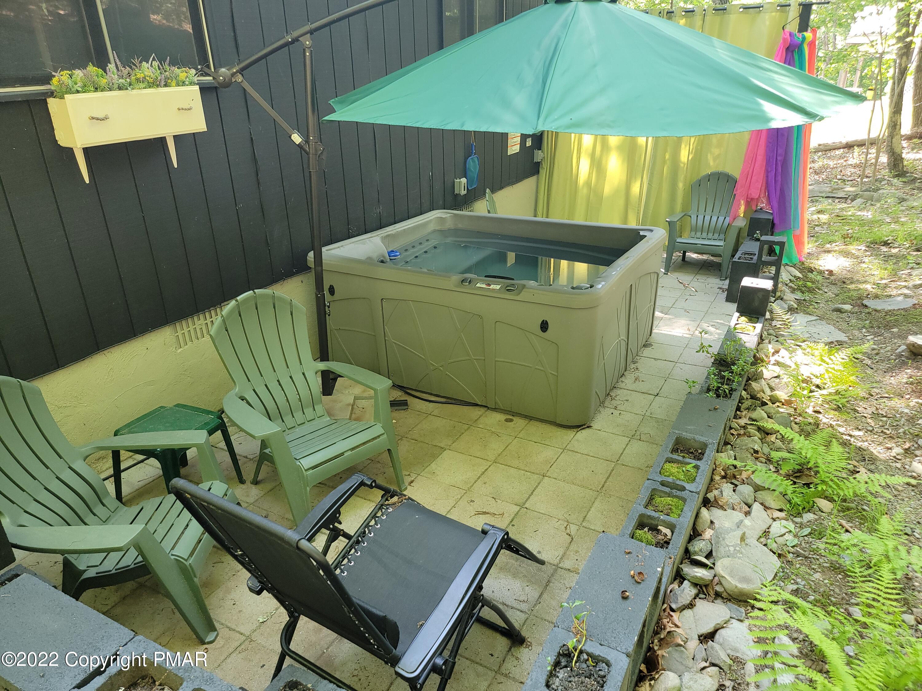 358 Brentwood Drive Bushkill, PA 18324 - Photo 37 of 59 a backyard of a house with table and chairs