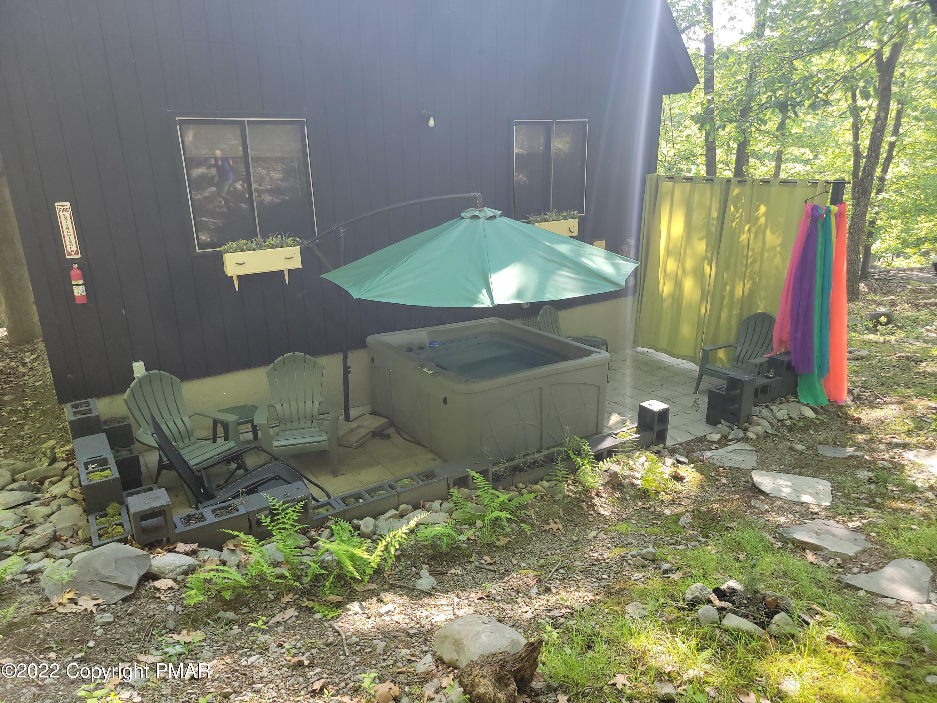 358 Brentwood Drive Bushkill, PA 18324 - Photo 44 of 59 a backyard of a house with table and chairs