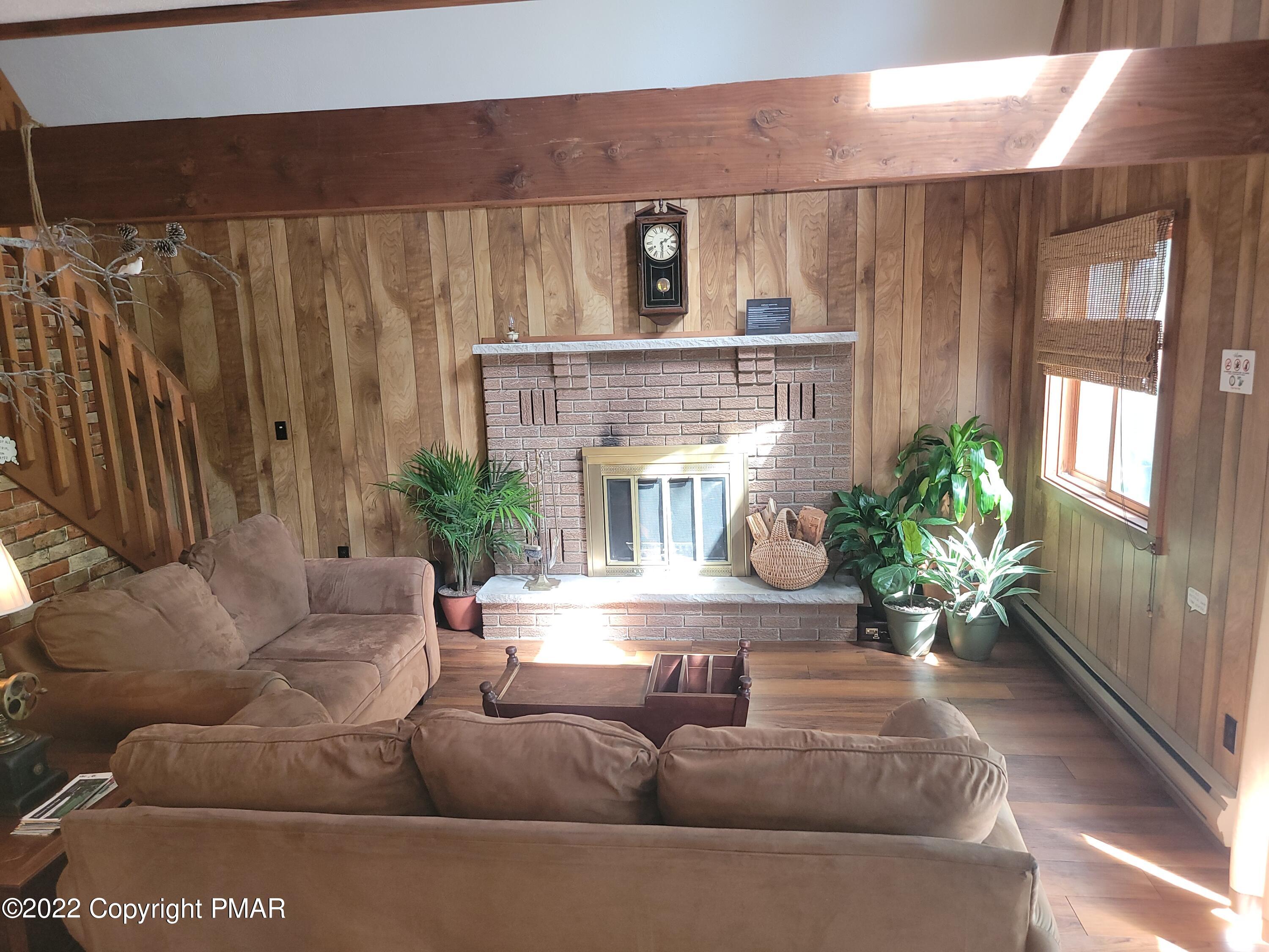 358 Brentwood Drive Bushkill, PA 18324 - Photo 7 of 59 a living room with furniture and a fireplace