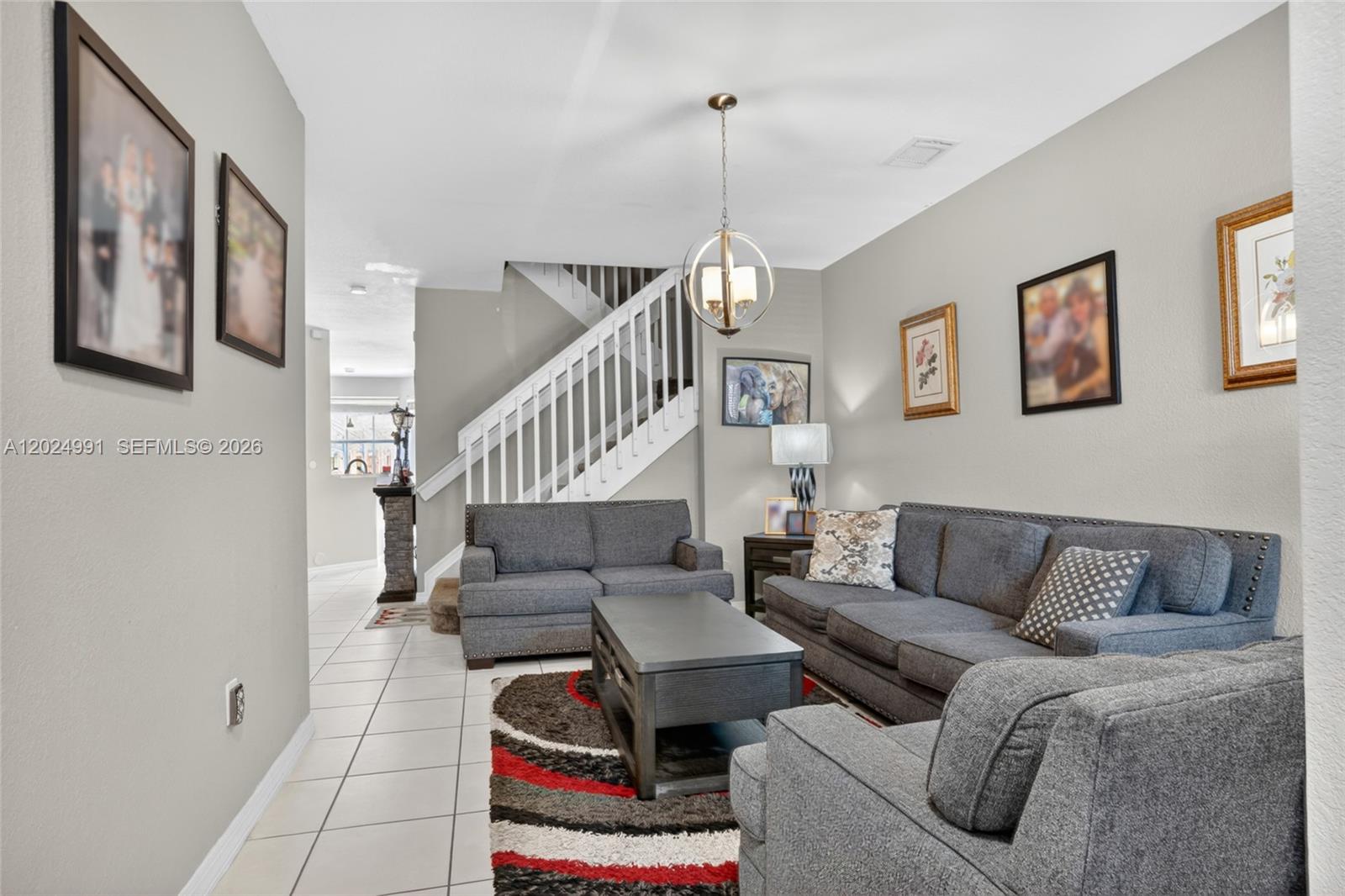 16651 Southwest 79th Terrace Miami, FL 33193 - Photo 4 of 34 a living room with furniture and a wooden floor